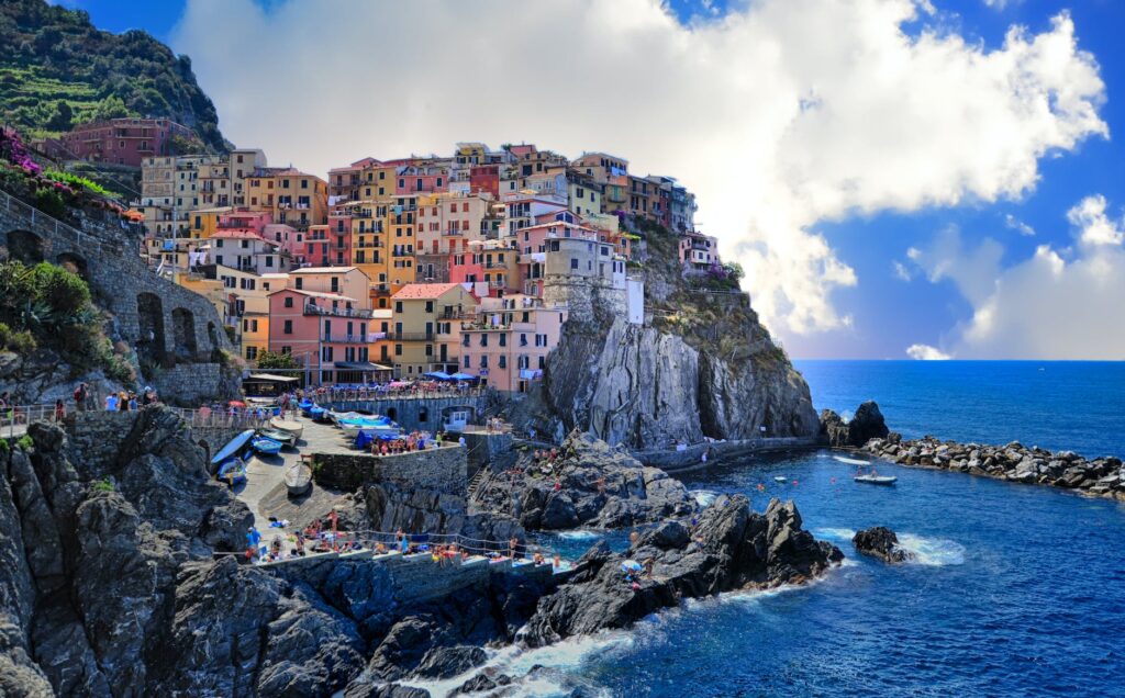 assorted color houses beside body of water