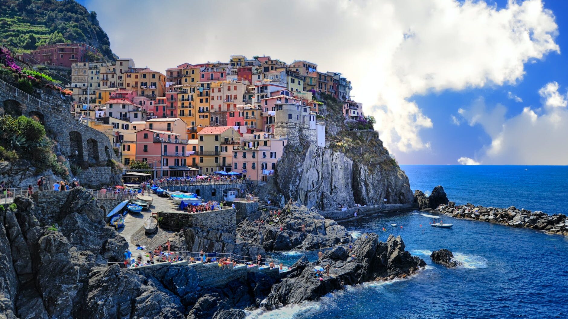 assorted color houses beside body of water